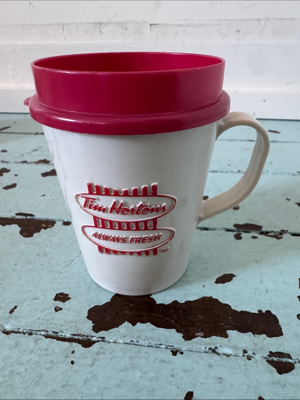Vintage Tim Hortons plastic travel coffee mug with a red snap-on lid, 1980-90s